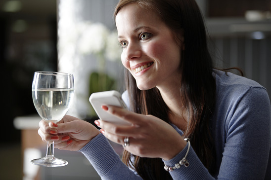 Image: Woman Texting and Drinking Wine