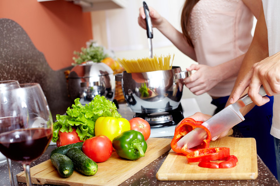 Image: Close-up of Woman Chopping Vegetables and Wine Glass