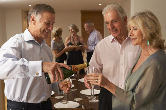 Image: Man Serving Champagne to Guests at Dinner Party