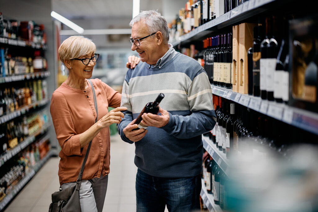 Couple buying wine in a grocery store