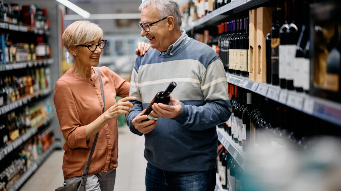 Couple buying wine in a grocery store